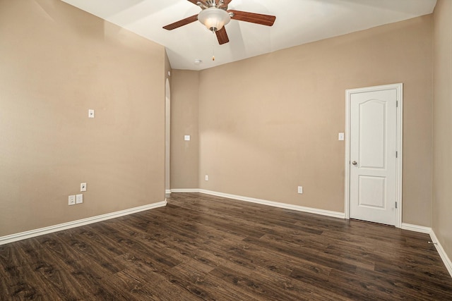 unfurnished room featuring dark wood-type flooring, a ceiling fan, and baseboards