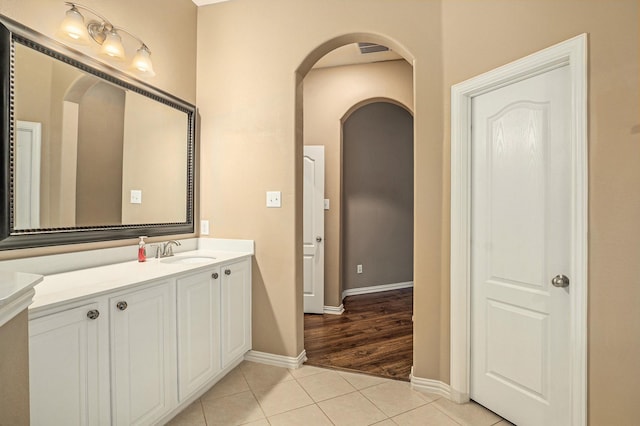 bathroom with tile patterned floors, visible vents, vanity, and baseboards