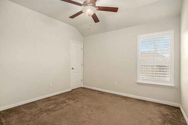 empty room with baseboards, ceiling fan, carpet flooring, and vaulted ceiling