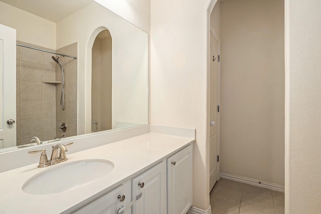 bathroom featuring tile patterned flooring, vanity, and baseboards