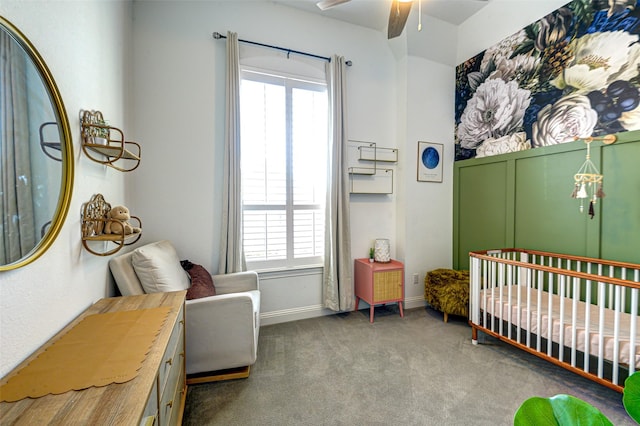 carpeted bedroom featuring a crib and baseboards