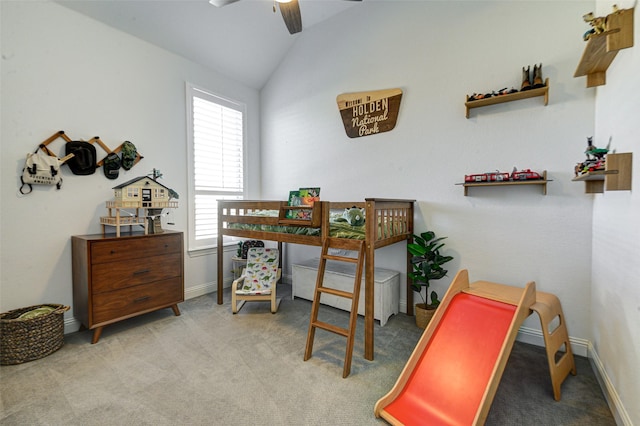 carpeted bedroom with a ceiling fan, vaulted ceiling, and baseboards