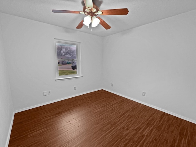 unfurnished room with a ceiling fan, baseboards, and wood finished floors