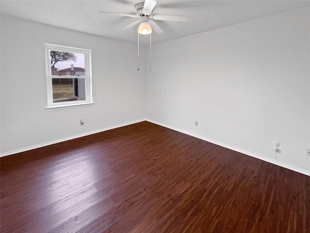 spare room with ceiling fan, a textured ceiling, baseboards, and wood finished floors