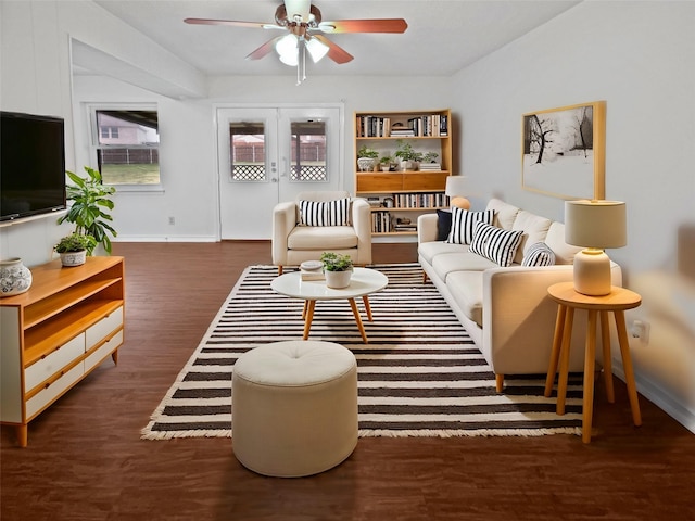 living room featuring baseboards, a ceiling fan, and wood finished floors