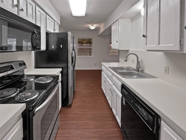 kitchen with black appliances, white cabinetry, light countertops, and a sink