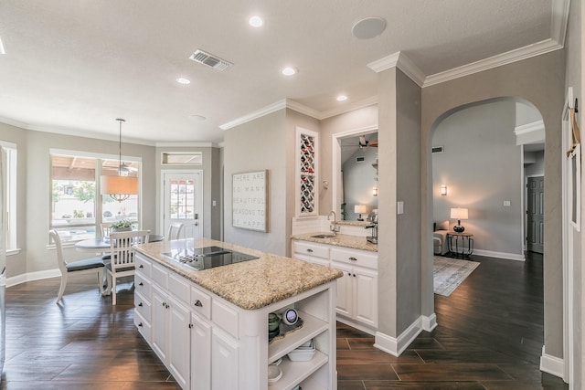 kitchen featuring white cabinets, open shelves, visible vents, and black electric cooktop