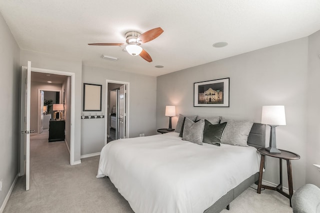 bedroom with a ceiling fan, light colored carpet, and baseboards