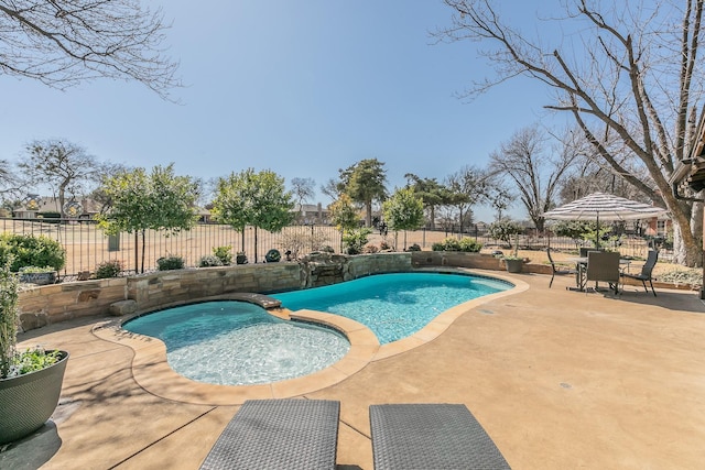 view of swimming pool with a patio, a fenced backyard, and a pool with connected hot tub