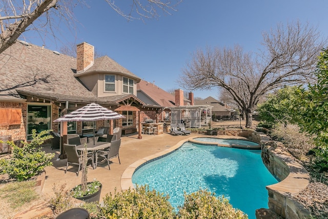 view of swimming pool featuring a patio, fence, a fenced in pool, and an in ground hot tub