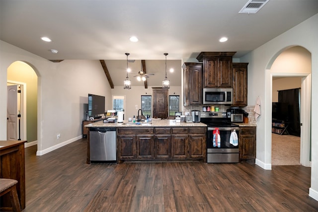 kitchen featuring lofted ceiling with beams, stainless steel appliances, a sink, visible vents, and dark brown cabinets