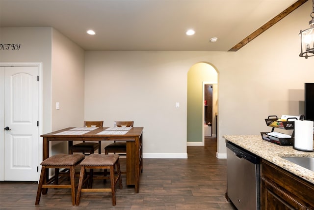 dining room featuring dark wood-style floors, baseboards, arched walkways, and recessed lighting