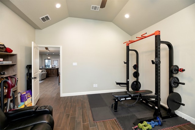 workout room featuring vaulted ceiling, wood finished floors, visible vents, and baseboards