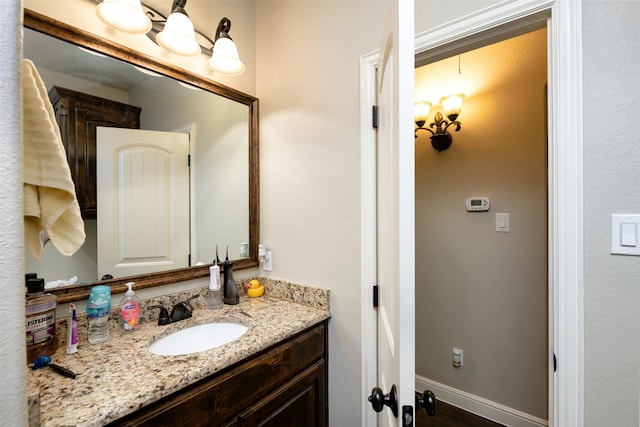 bathroom with vanity and baseboards