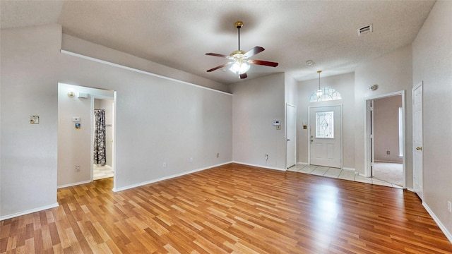 entrance foyer with a ceiling fan, visible vents, light wood-style flooring, and baseboards