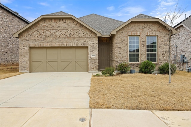 view of front of property with an attached garage, a shingled roof, concrete driveway, and brick siding