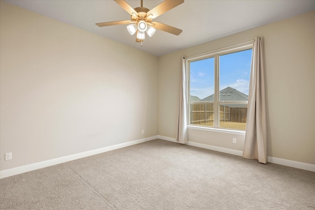 empty room featuring ceiling fan, baseboards, and carpet flooring