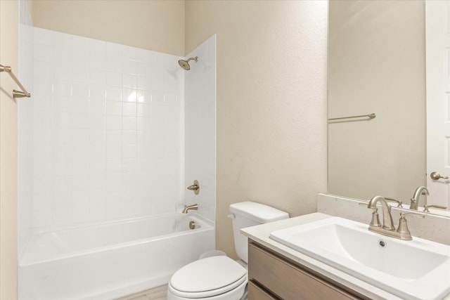 full bath featuring toilet, a textured wall, shower / washtub combination, and vanity