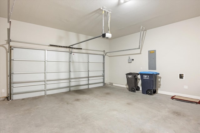 garage with a garage door opener, electric panel, and baseboards