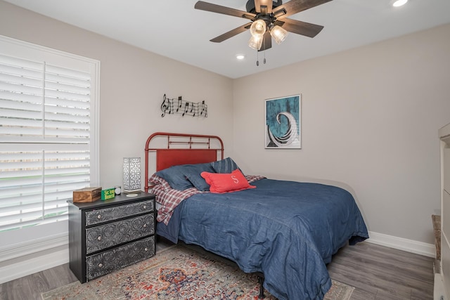 bedroom with recessed lighting, baseboards, and wood finished floors