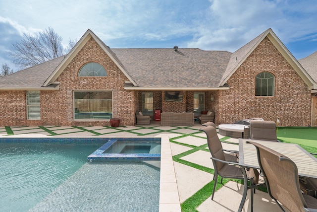 view of swimming pool with a pool with connected hot tub, a patio area, and an outdoor living space