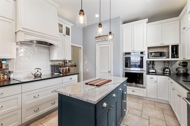 kitchen featuring tasteful backsplash, appliances with stainless steel finishes, and white cabinets