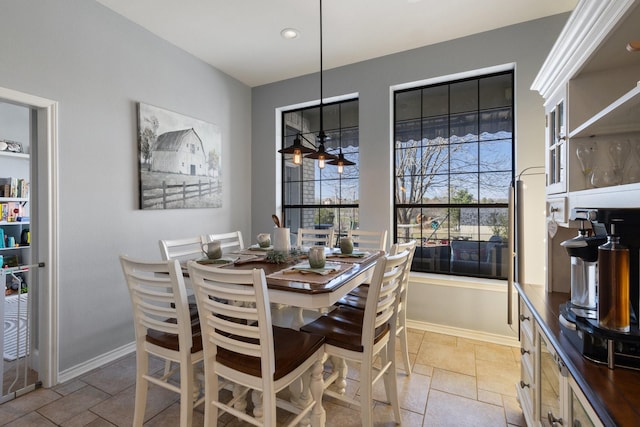 dining area with stone tile flooring and baseboards