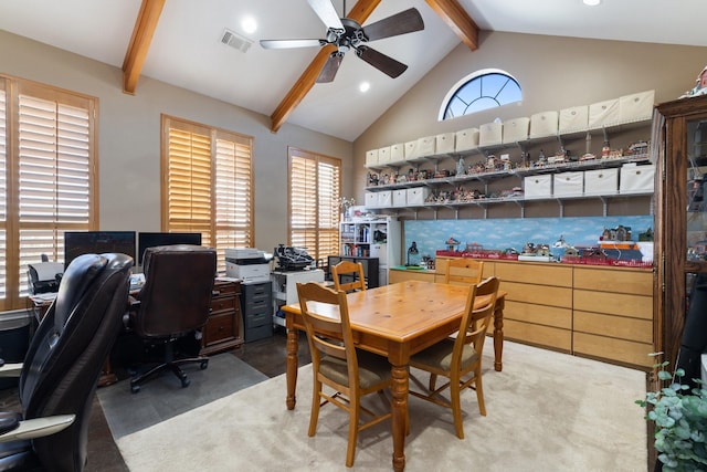 home office featuring lofted ceiling with beams, visible vents, a ceiling fan, and light colored carpet