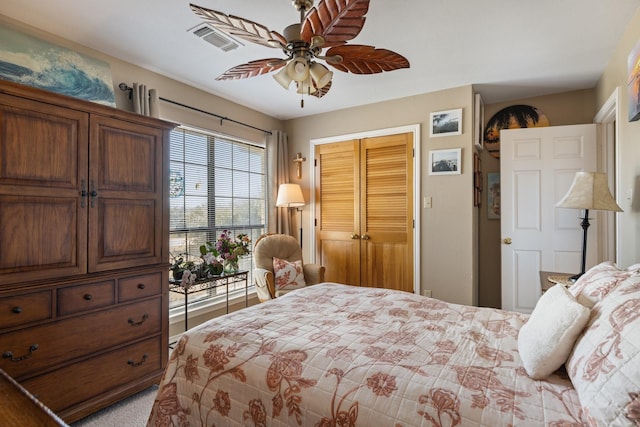 bedroom featuring ceiling fan, visible vents, and a closet