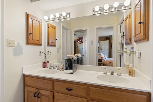 full bathroom featuring connected bathroom, a sink, and double vanity