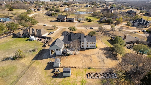 drone / aerial view with a water view and a residential view