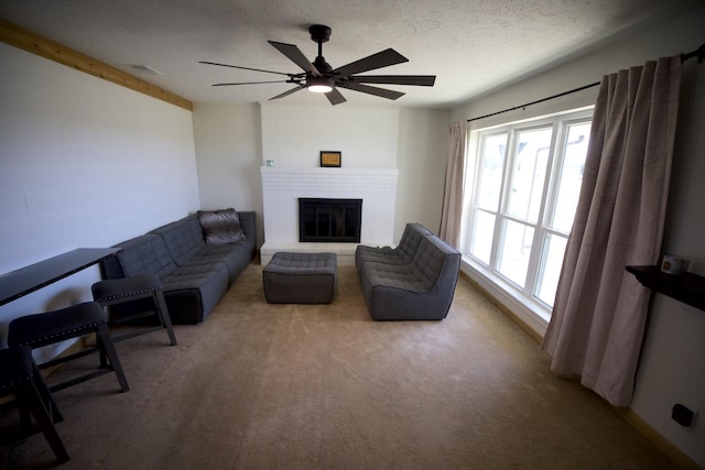 living room with light carpet, a textured ceiling, a brick fireplace, and visible vents