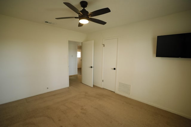 unfurnished bedroom featuring light carpet, ceiling fan, and visible vents