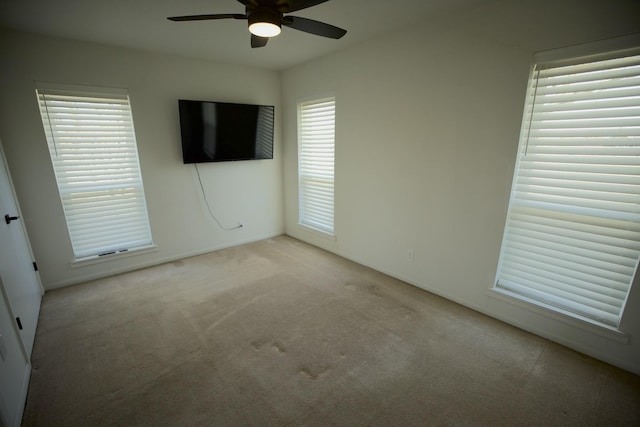 unfurnished bedroom featuring ceiling fan and carpet