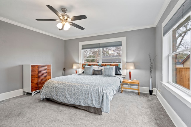 carpeted bedroom featuring multiple windows, baseboards, and ornamental molding