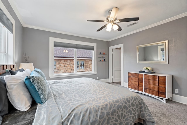 carpeted bedroom featuring baseboards, visible vents, ceiling fan, and ornamental molding