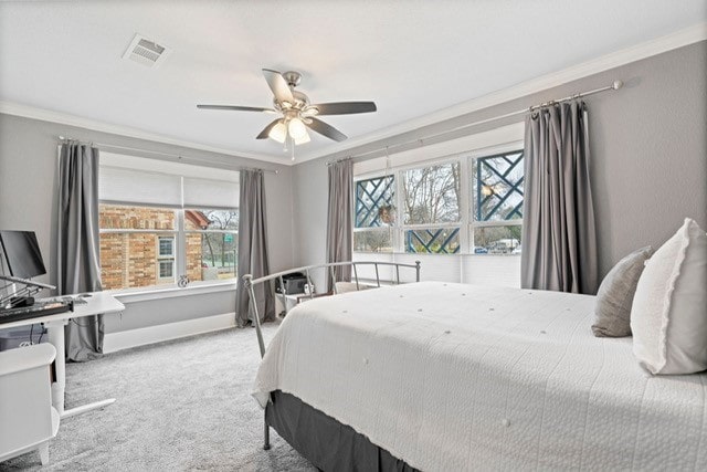 bedroom with multiple windows, visible vents, crown molding, and carpet flooring