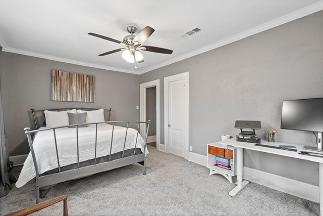 bedroom with carpet floors, visible vents, crown molding, and baseboards