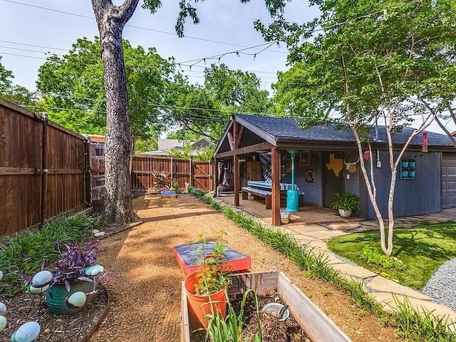 view of yard featuring a fenced backyard and a vegetable garden