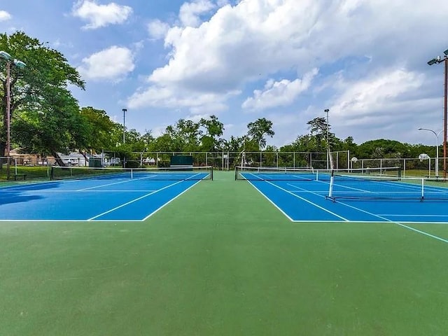 view of tennis court featuring fence