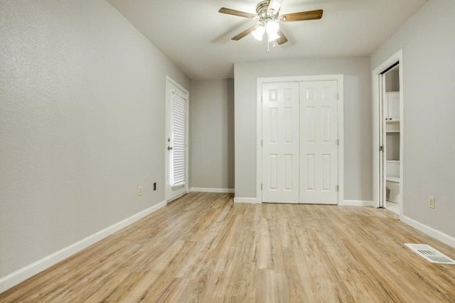 unfurnished bedroom featuring a ceiling fan, light wood-type flooring, visible vents, and baseboards