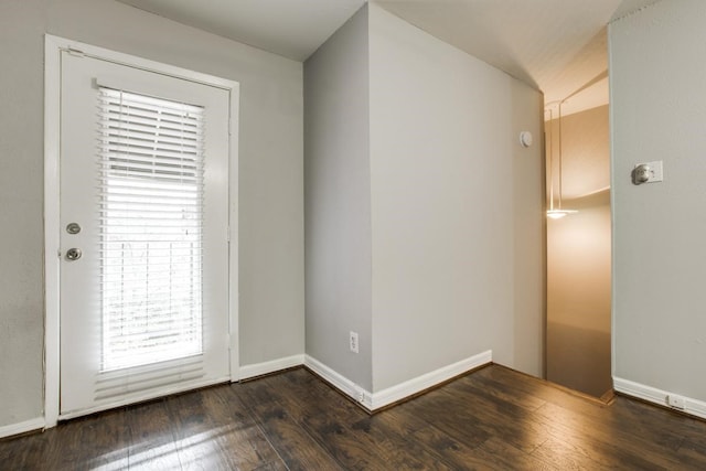 doorway to outside with baseboards and wood finished floors