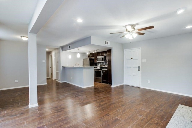 unfurnished living room with a ceiling fan, visible vents, dark wood finished floors, and baseboards