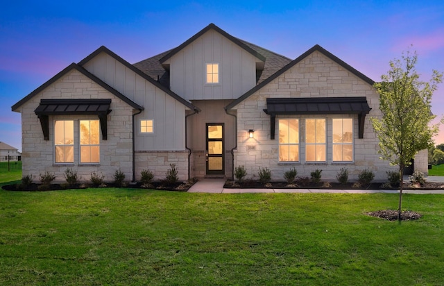 5509 Gaelic Dr, Celina, TX 75009 - view of front of property featuring a front yard, board and batten siding, stone siding, and a shingled roof