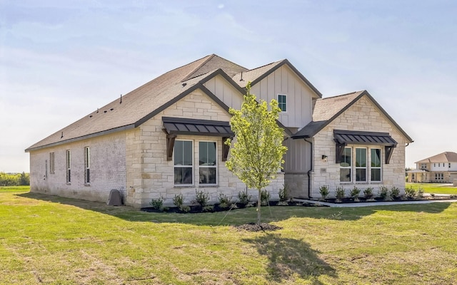 5509 Gaelic Dr, Celina, TX 75009 - view of front of property featuring a front yard, board and batten siding, and stone siding