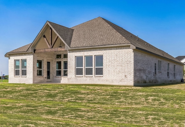 5509 Gaelic Dr, Celina, TX 75009 - back of house with a yard, a shingled roof, and brick siding
