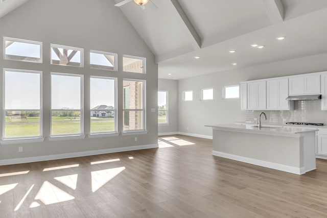 5509 Gaelic Dr, Celina, TX 75009 - kitchen with tasteful backsplash, light wood-style flooring, white cabinets, gas stovetop, and a sink