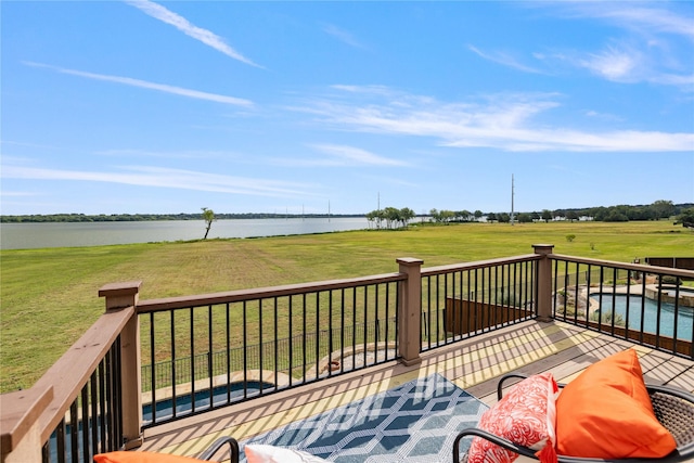 deck with a water view and a yard