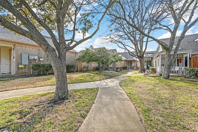 view of home's community featuring a residential view, fence, and a yard