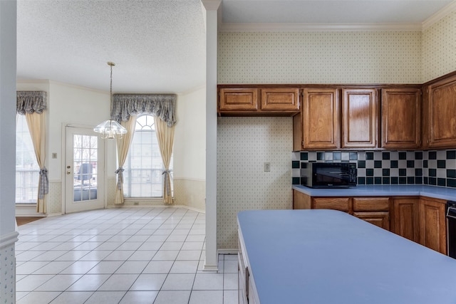 kitchen with wallpapered walls, wainscoting, brown cabinets, crown molding, and a textured ceiling